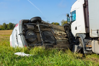 Car accident on a road in September, car after a collision with a heavy truck, transportation background