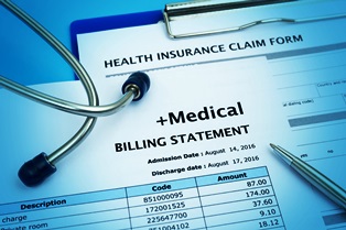 Healthcare cost concept with medical bill and health insurance claim form